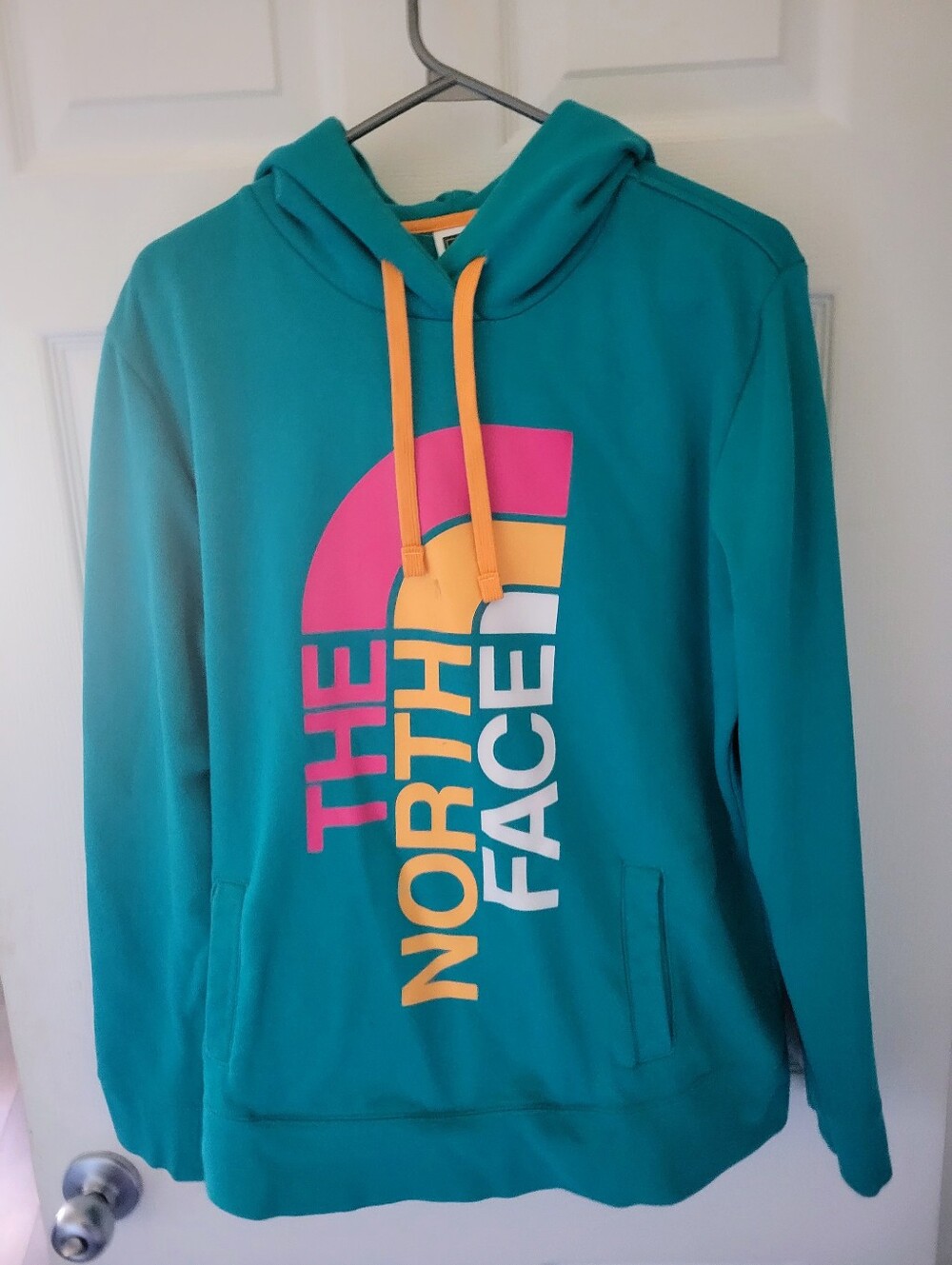 The North Face Teal Hoodie with Yellow Drawstrings and Multicolor Logo